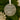 A clear ornament with a white ribbon and paw prints hanging on a Christmas tree.